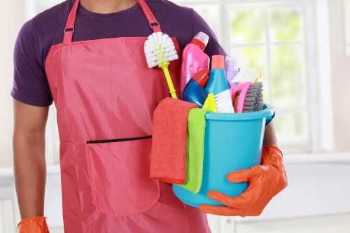 Technician using protective equipment during carpet cleaning tasks