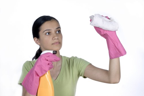 Cleaner wearing PPE while operating carpet cleaning equipment